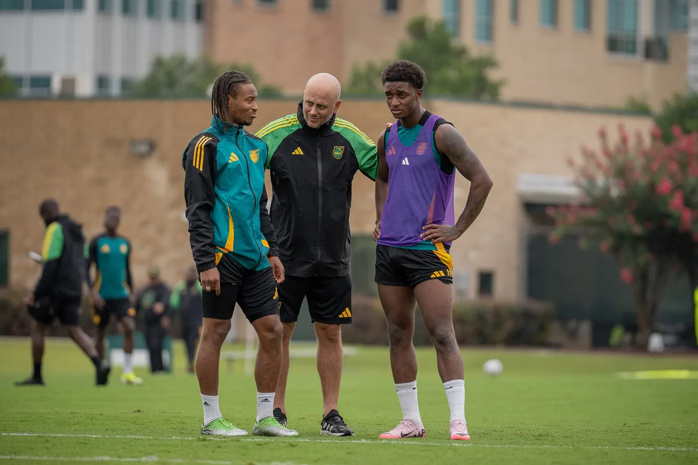 John Wall talking with two Jamaica national team players at a training session