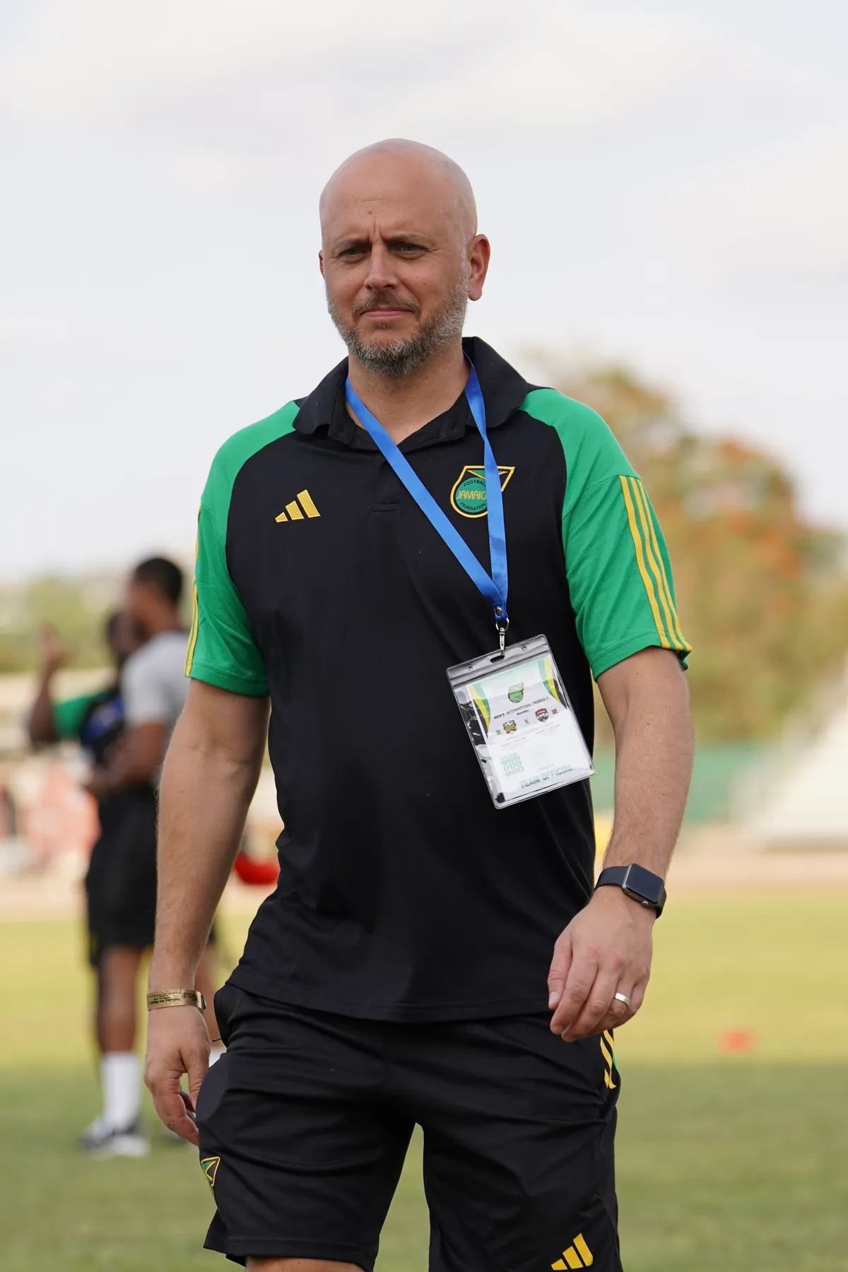 John Wall on the pitch in Jamaica Football Federation kit wearing a team official matchday credential